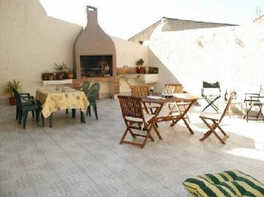 Communal sun terrace with bbq, lots of seating and 2 sunbeds