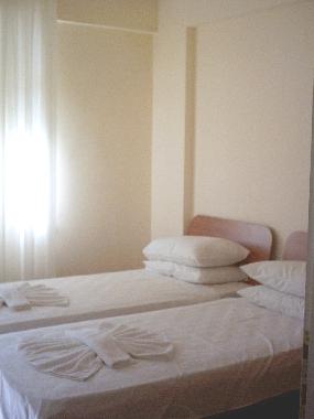 Clean and comfortable twin bedroom with balcony.