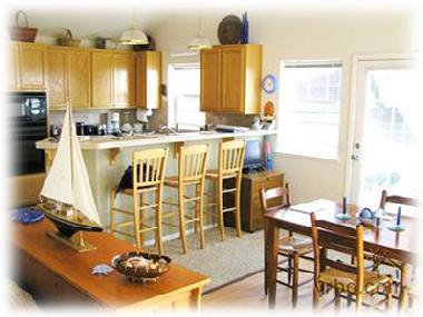 Dining room & fullsize kitchen w/ door to upper deck