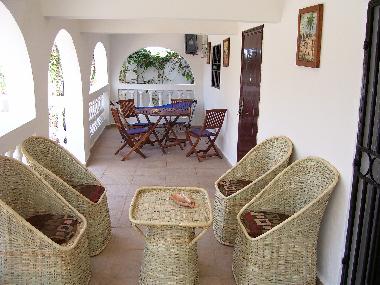 Verranda seating area overlooking paved patio