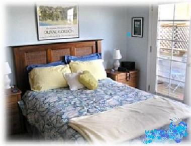 Master bedroom w/ queen bed & door to lower deck. Let sounds of surf lull you to sleep.