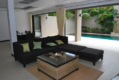 Spacious living area opens to the terrace, pool and tropical garden