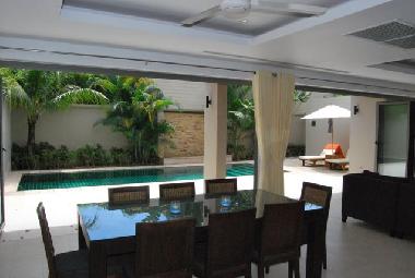 The dining area seats 8 and opens to the pool