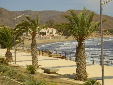 Isla Plana promenade and sandy beach with play area nearby  