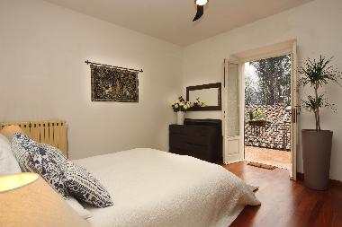 Bedroom 1 with a spectacular view over the mountains and the antique wall. Bedroom 1 has a private t
