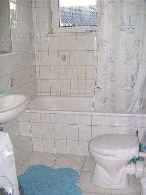 Bathroom with shower, bathtub and washing machine