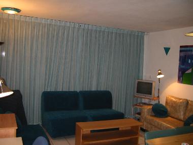 Living room has 3 single seat couches that open up to beds