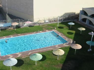 View from terrace of complex pool and grassy area