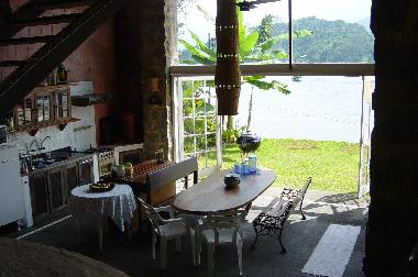Kitchen, living room garden and the ocean in the background