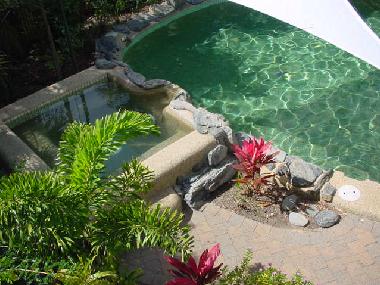 View over the swimming pool and jacuzzi from the main bedroom