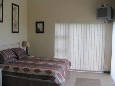 Main Bedroom (en-suite) with slidingdoors and private patio