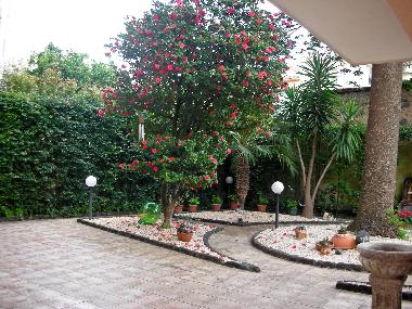 the garden adorned with pinkish pebbles and lava stones