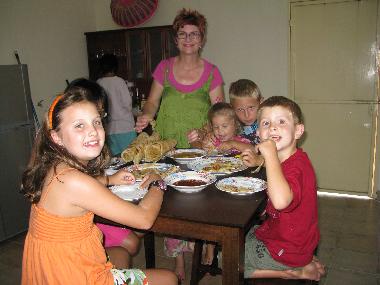Happy guests enjoying local food in the kitchen