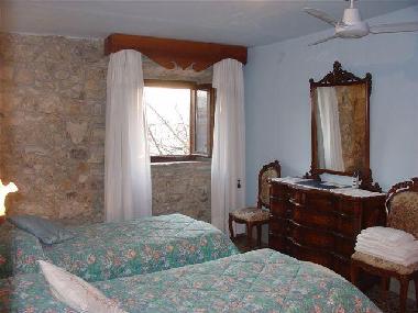 one of the twin beds room, country elegant style. Each bedroom has ceiling fans.