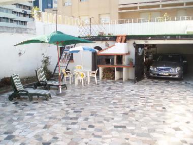 patio with barbecue, laundry corner and terrace above garage