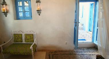 detail bedroom downstairs and doors leading onto courtyard