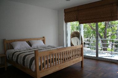 bright and airy master over looking tropical garden