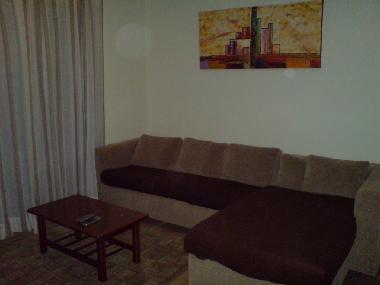 Large comfy sofa bed leading to balcony with pool view