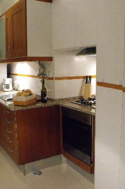 Kitchen with fridge/freezer, coffee machine, hob/oven and microwave