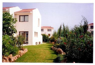 Walk barefoot on the soft green grass leading to the pool area