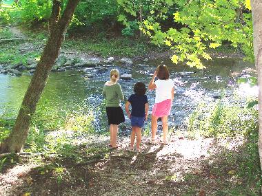 Three young visitors at the river on our farm