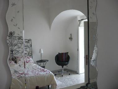 Double en suite bedroom with vaulted ceiling and double doors onto balcony.