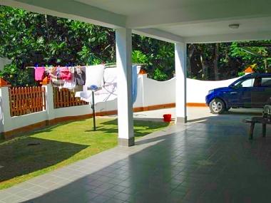 ( A ) - Garage area, with clothesline in court yard. Also has another folding close line on the wall