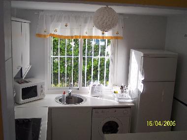 Light and fully equipped kitchen.