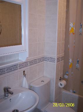 Ensuite bathroom with bathtub.