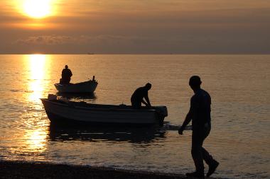 Bringing in the boats at sunset on the adjoining beach.