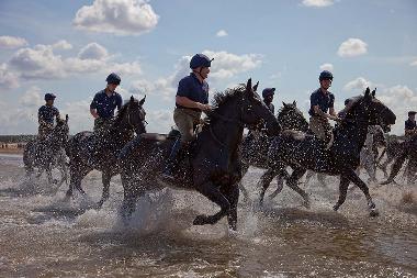 The Royal Household Cavalry exercise their horses on Holkham bea