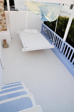 hanging double bed on 2nd floor, with big walls around, mosquitonet and pergola for shade