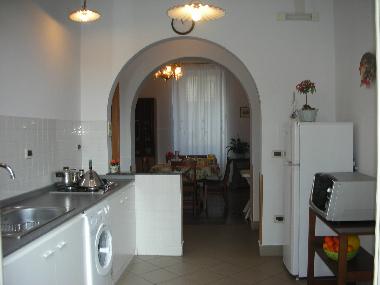 a large kitchen connecting to the dining room