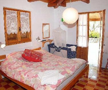 Double bedroom and cot in cottage