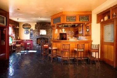 Comfortable front bar with open turf and stove fires. We invite our guests to pull your own Guinness