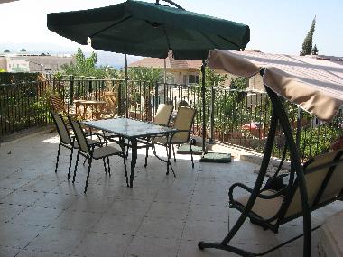 patio has many areas for your kids to play, a three-seat swing, large table, small table