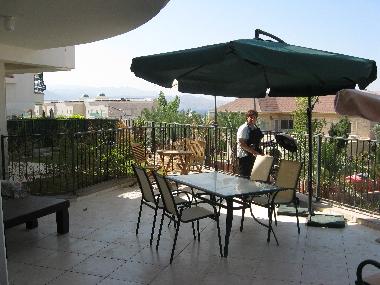 patio has couch and coffe table, barbecue grill