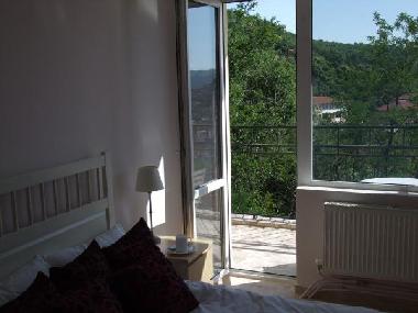 double bedroom with balcony access and views over Veliko Tarnovo old town