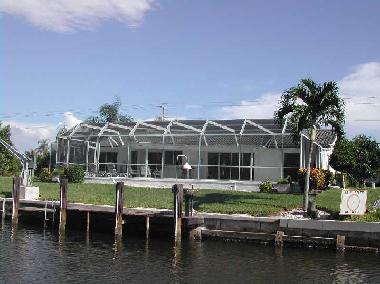 Rear of villa/pool area with small private dock