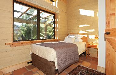 Second bedroom with king single bed and pull out bed.  Each room has views into the private garden