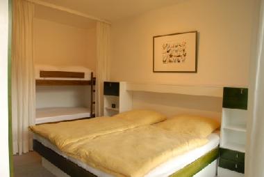 bedroom with big double bed and double deck bed