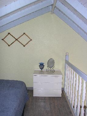 Another view of the bedroom which is situated in a loft above the living and dining areas. At right 