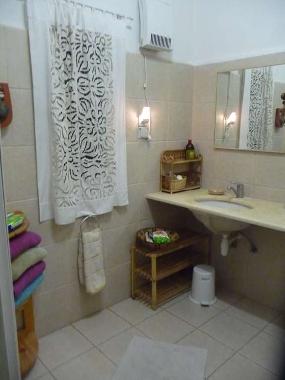 bathroom with shower unit and toilet