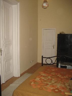 Bedroom with doors leading to living room and hallway to bathroom