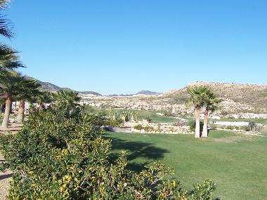 The golf course surrounded by mountains