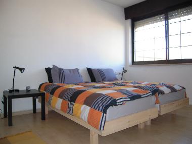 Master bedroom with two twin beds.  Linens are high quality sateen sheets.  There are 2 Japanese bat