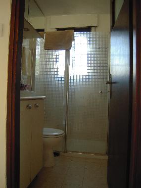 Bathroom with stall shower.