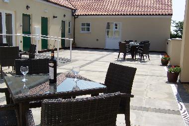 Greetham Retreat -  View of courtyard with Roses Rest Cottage shown at far end.