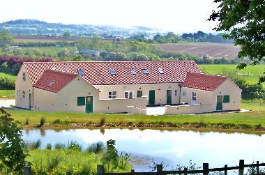 Greetham Retreat viewed across the wildlife pond.  Roses Rest is on the right hand side of the build