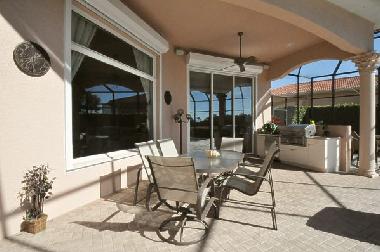 covered lanai with outside dining area and gas BBQ grill